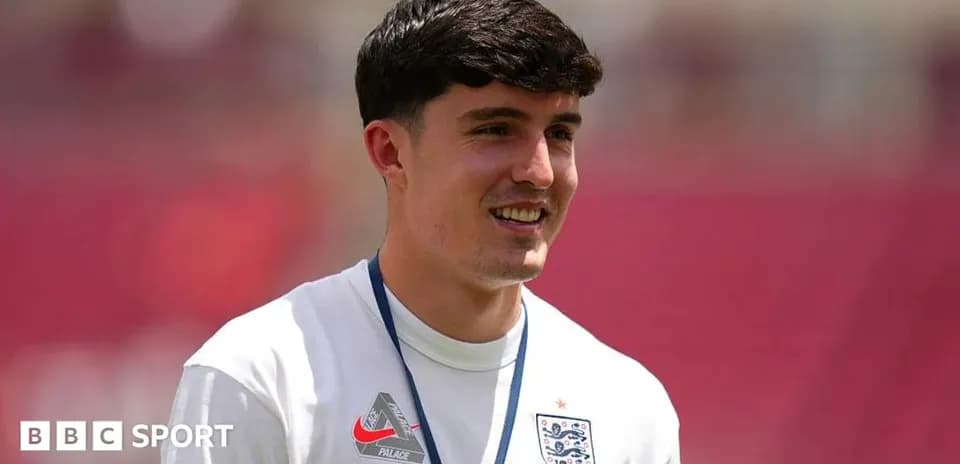 Player in England jersey smiling during warm-up