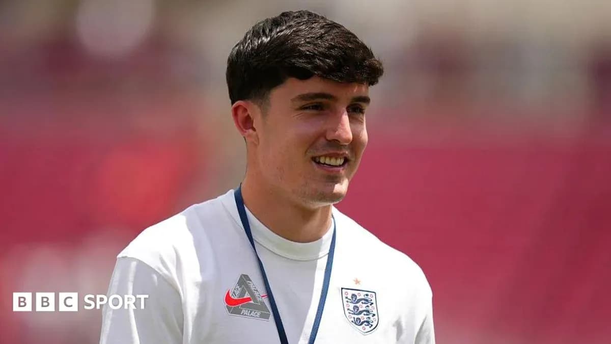 Player in England jersey smiling during warm-up