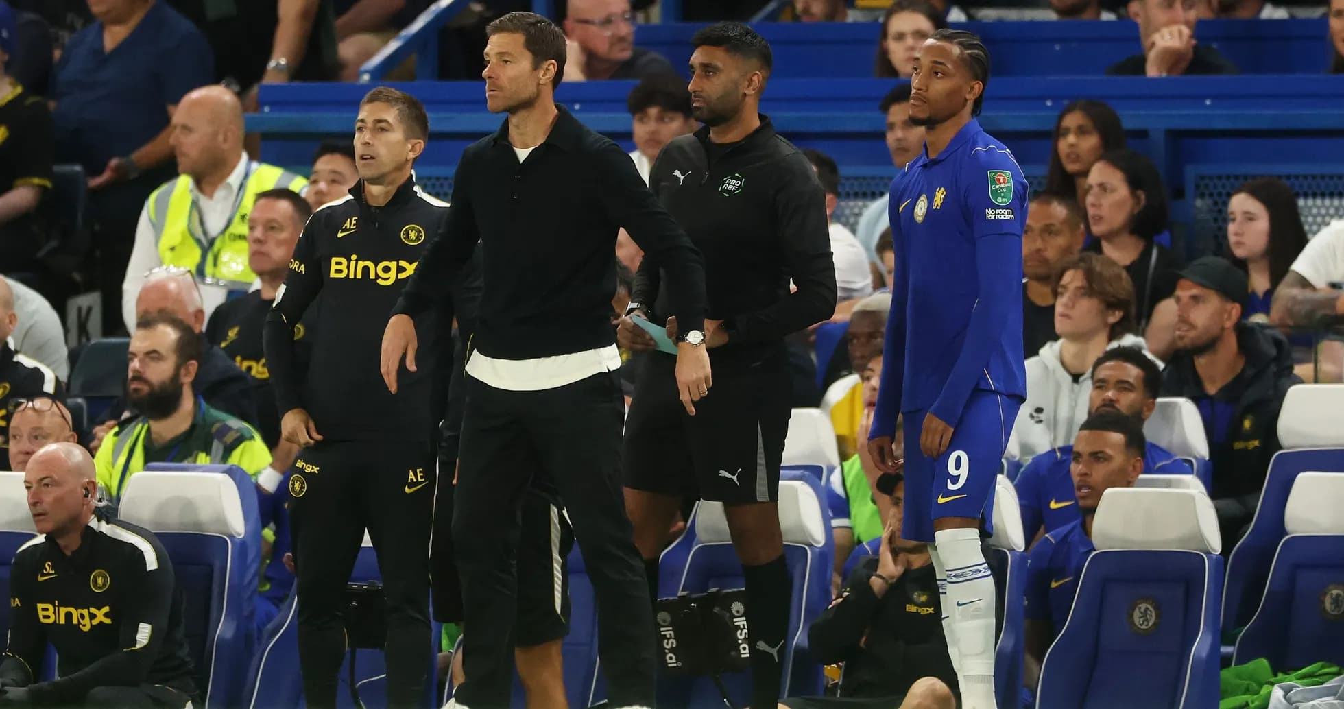 Coaches and player on the sidelines during match