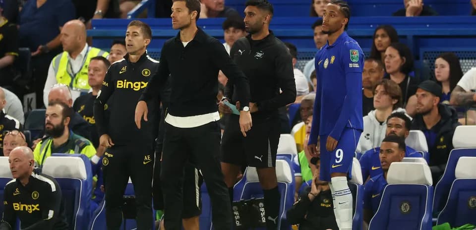 Coaches and player on the sidelines during match