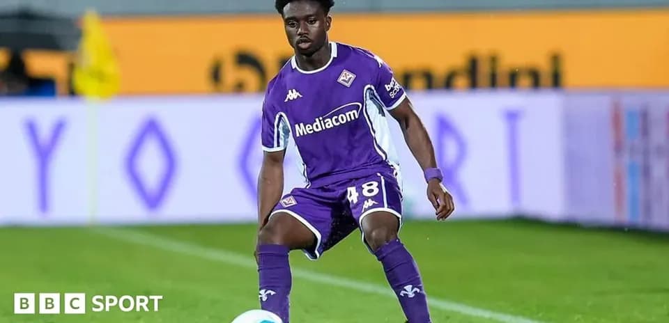 Player in purple kit preparing for play on field