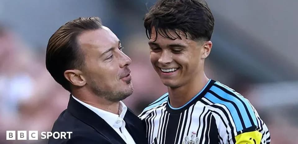 Manager and player sharing a moment on pitch