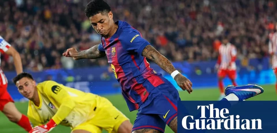 Barcelona player striking the ball against goalkeeper