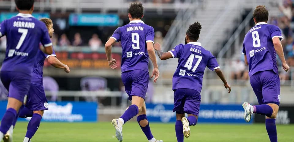 Louisville City players celebrating a goal