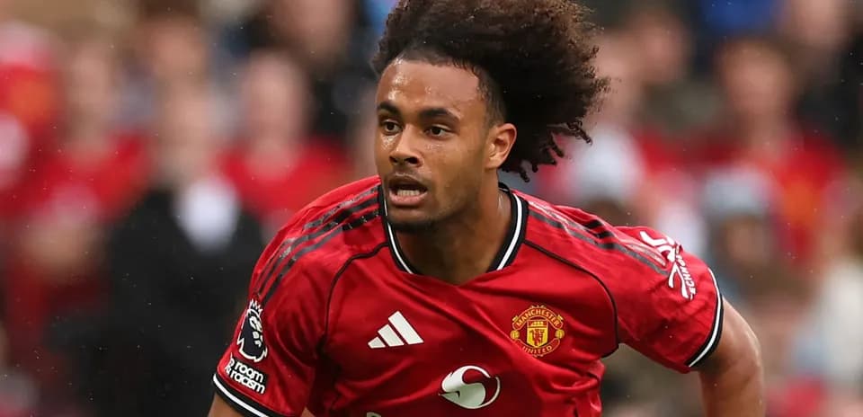 Player sprinting in Manchester United red jersey