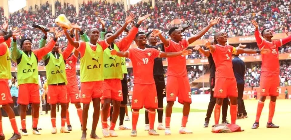 Football team celebrating with fans in stadium