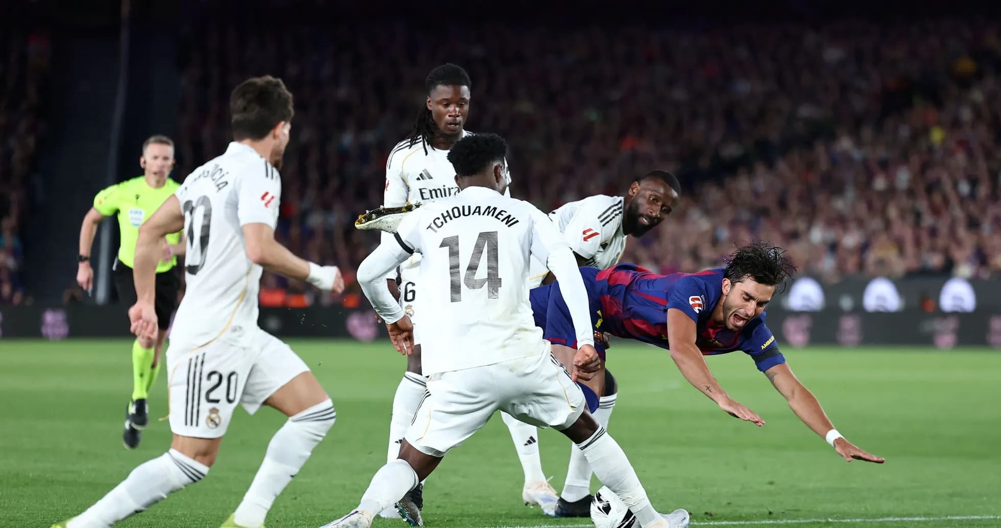 Barcelona player falling during match against Real Madrid