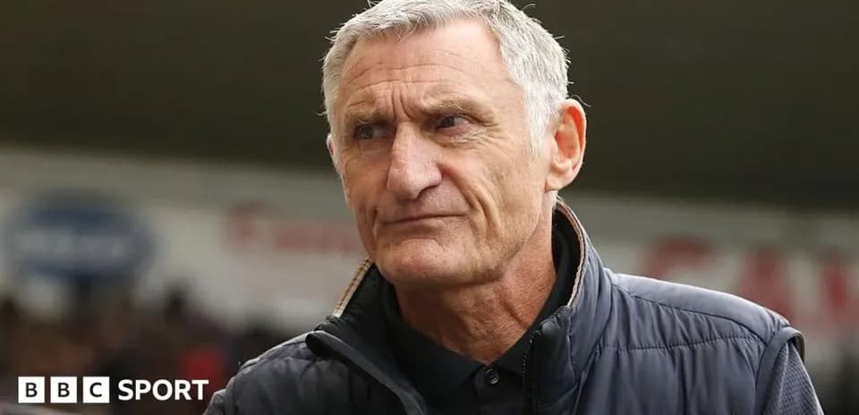 Coach standing on the sidelines during a match