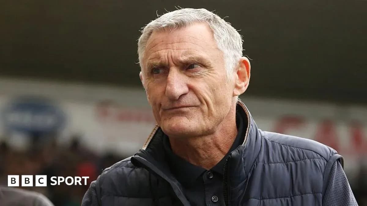 Coach standing on the sidelines during a match