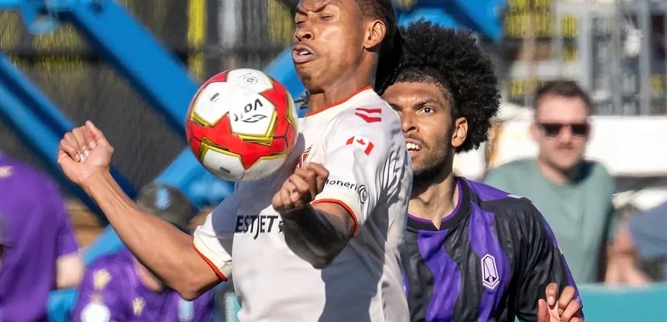 Cavalry FC player contests ball against Pacific FC opponent
