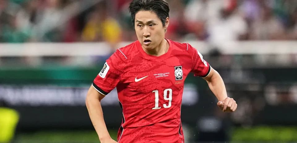 Player in red jersey running during match