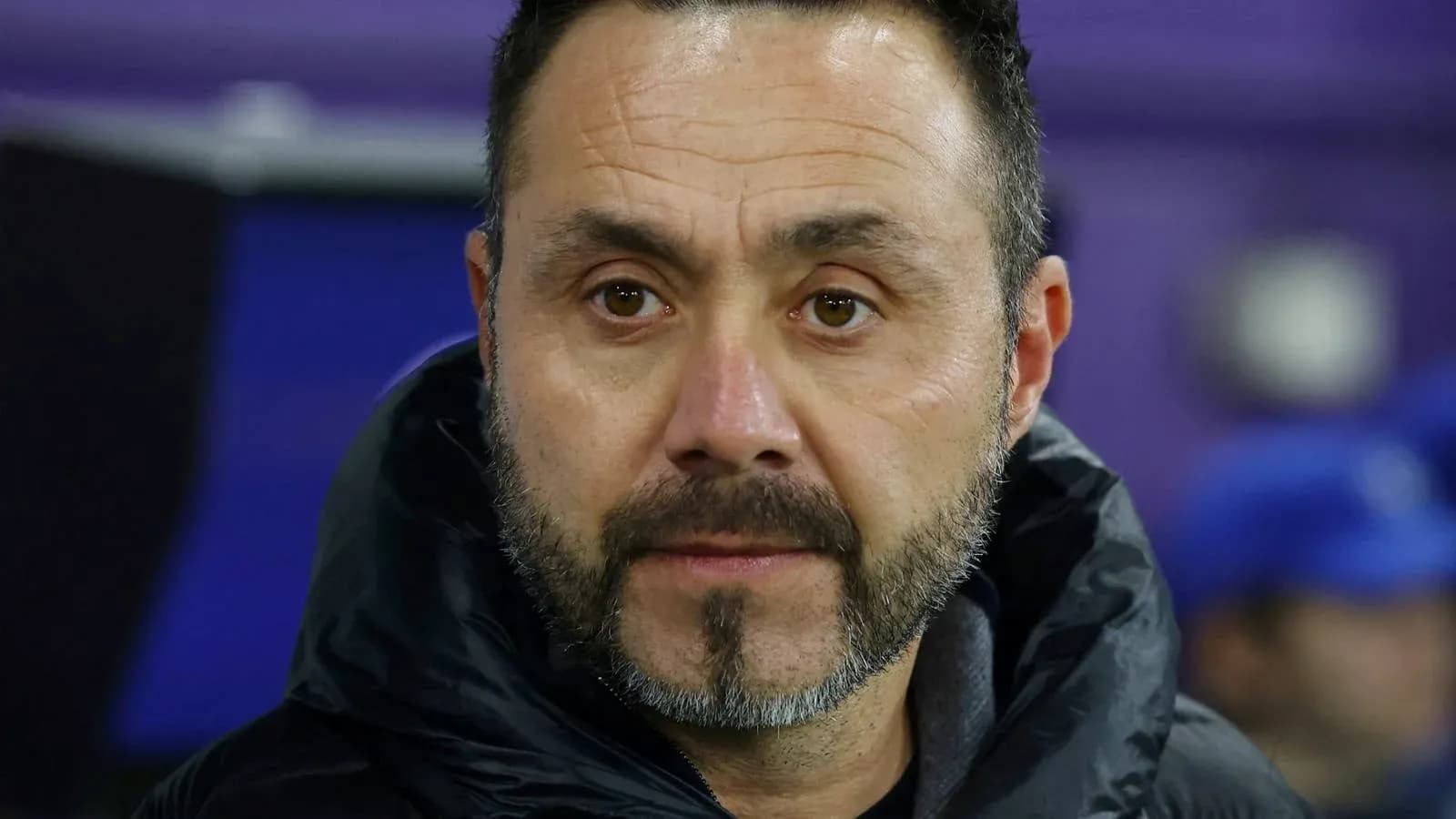Coach observing match from sidelines
