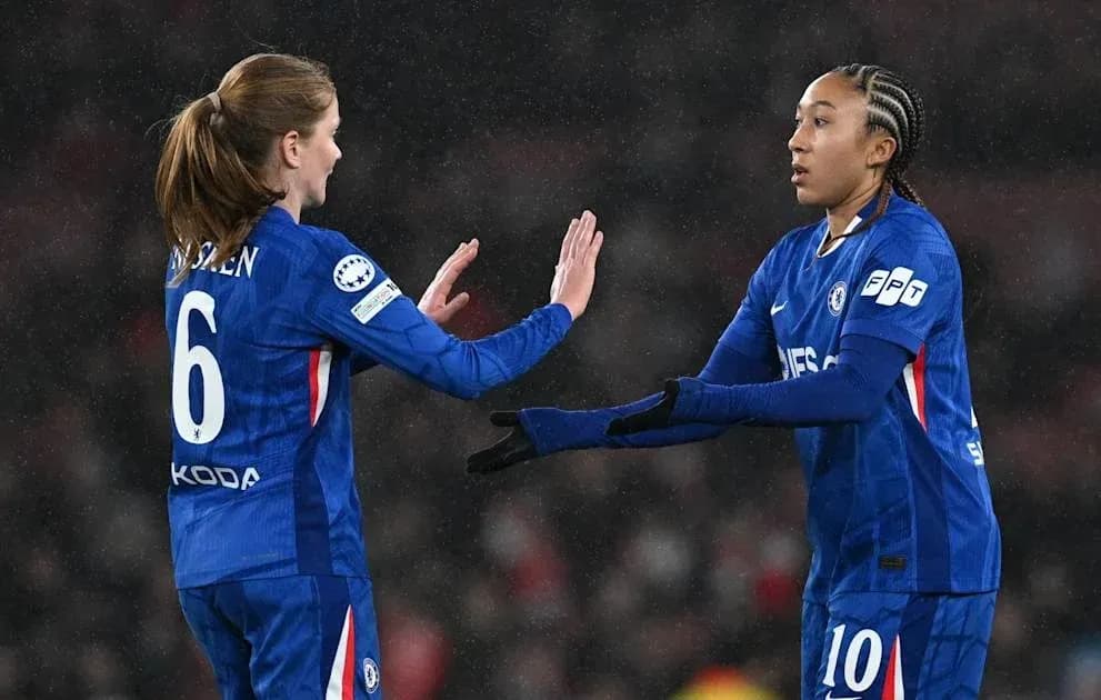 Two Chelsea players exchanging gestures on the field