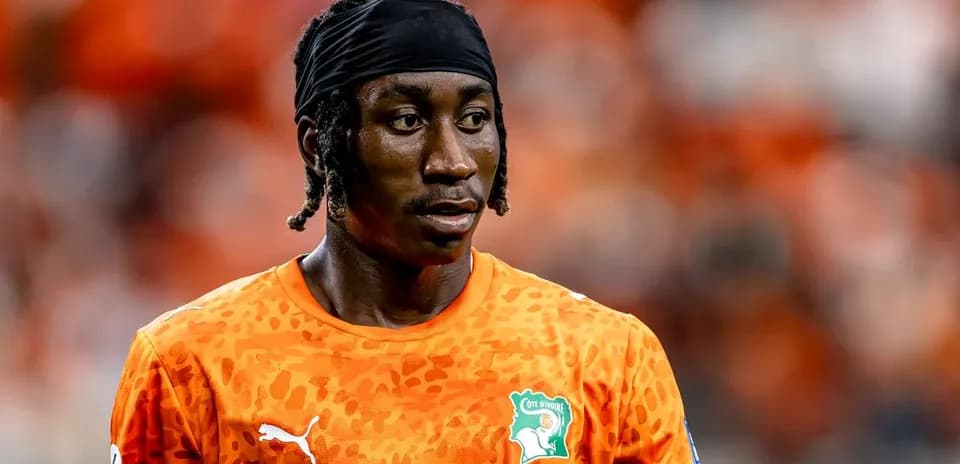 Player in orange jersey during match warm-up