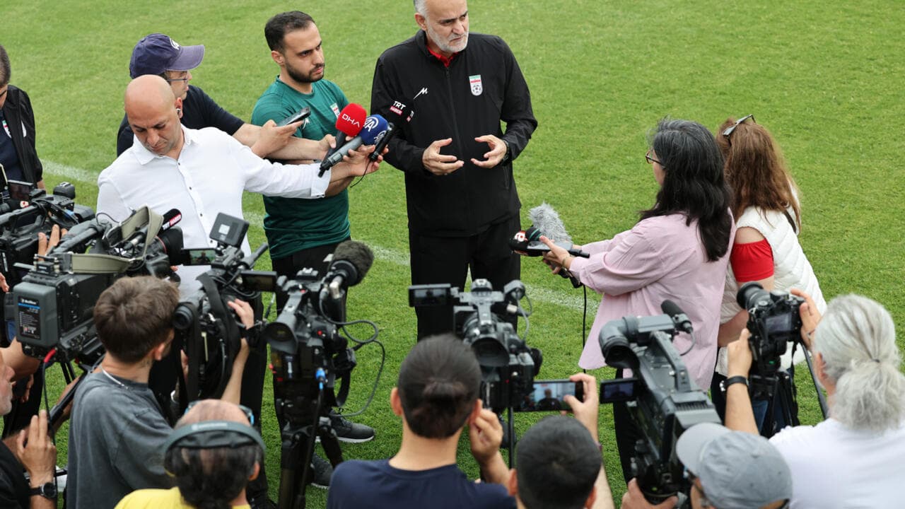 Coach speaking to reporters during press conference