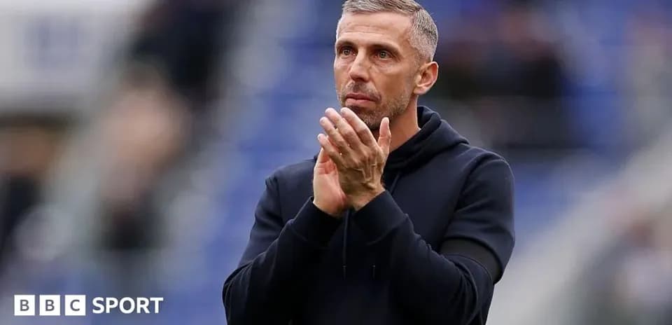 Coach clapping hands on the sidelines during match