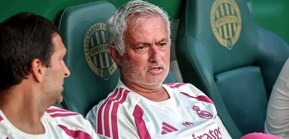 Manager and player seated on team bench