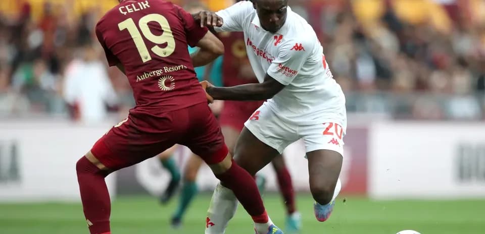 Celik and player competing for the ball