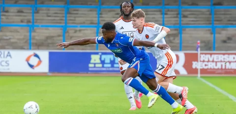 Player tackling opponent during a football match