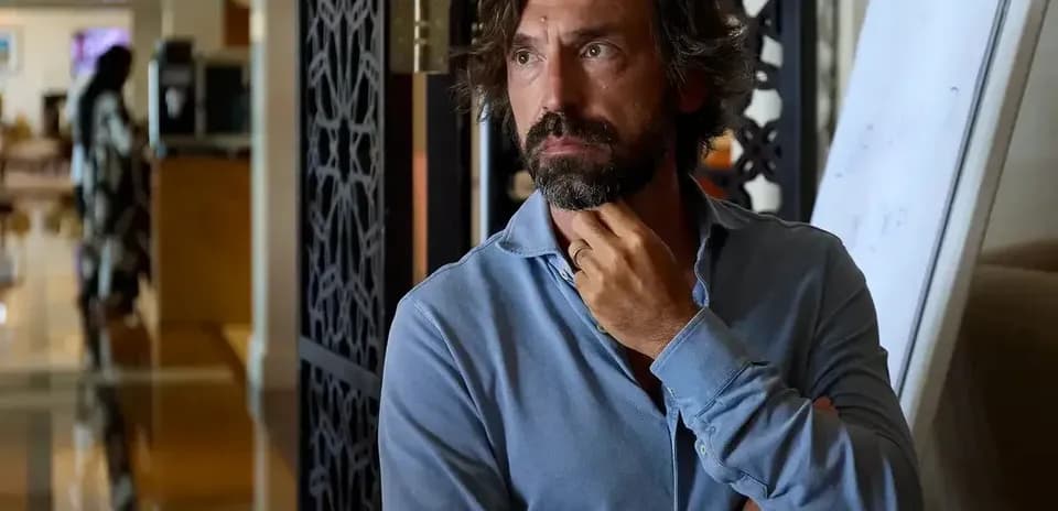 Man in blue shirt thinking in an indoor setting