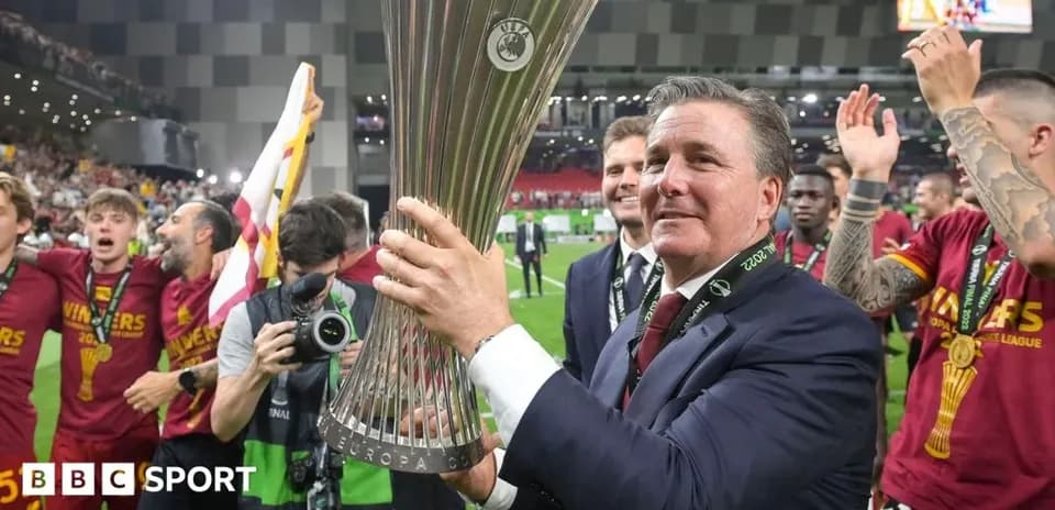 Coach celebrating with UEFA Europa Conference League trophy