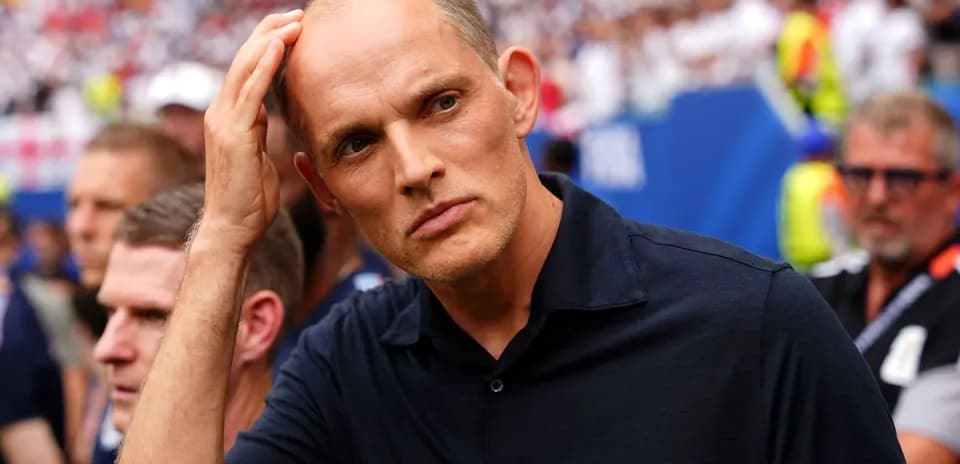 Coach observing match with concerned expression