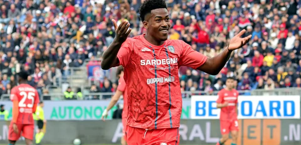 Player celebrating in red jersey during match