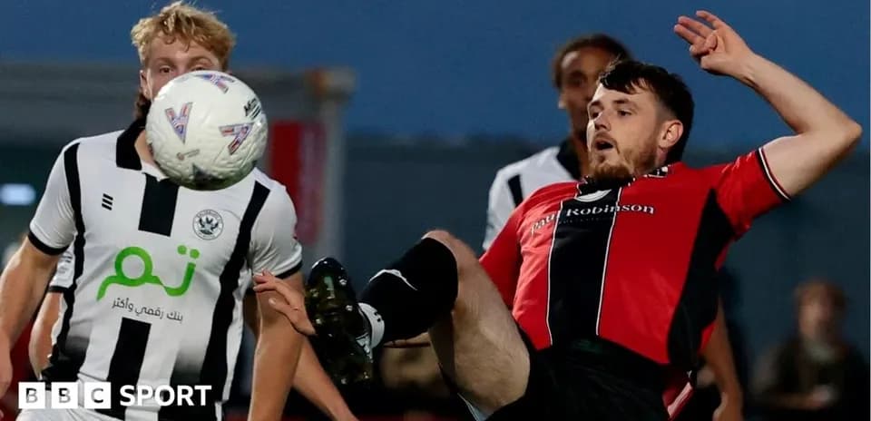 Player kicking ball during competitive match action