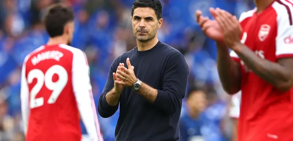 Manager clapping during match with players in background
