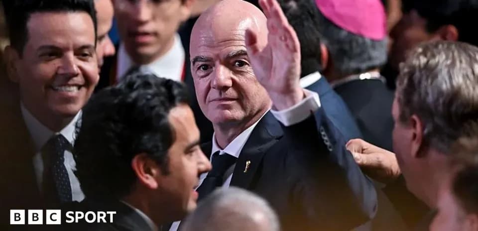 Man waving at an event surrounded by attendees