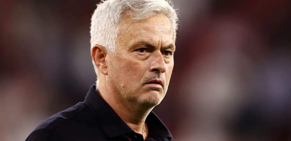 Coach observing the match with a serious expression
