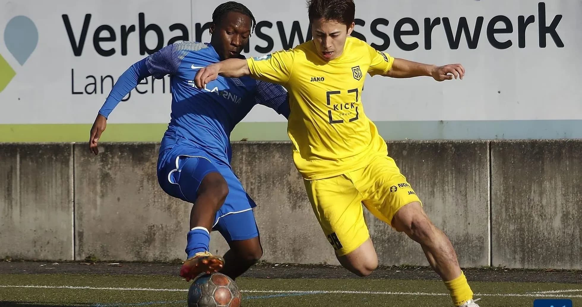 Two players competing for the ball in football match
