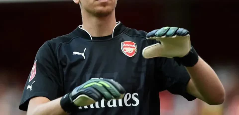 Goalkeeper warming up before match in Arsenal kit