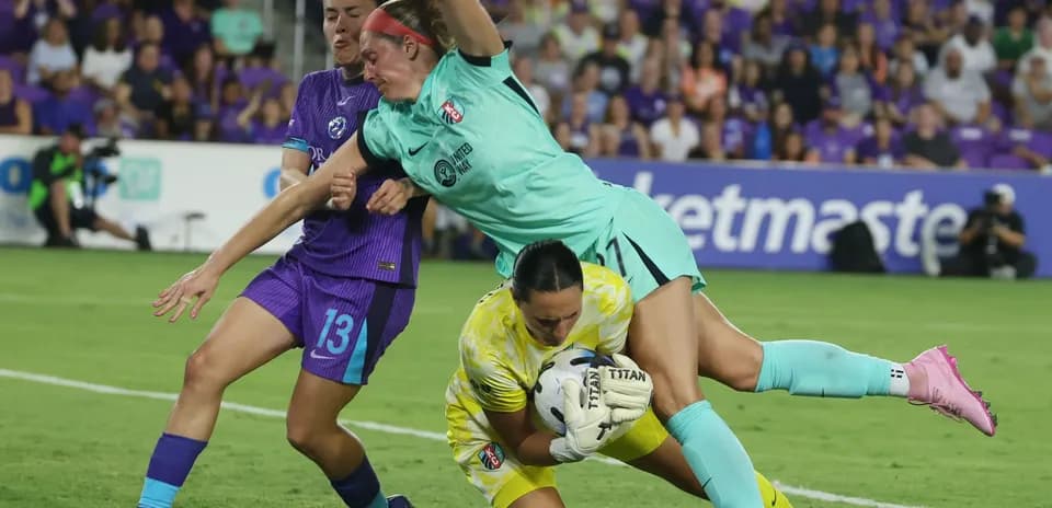 Goalkeeper making a save during NWSL match