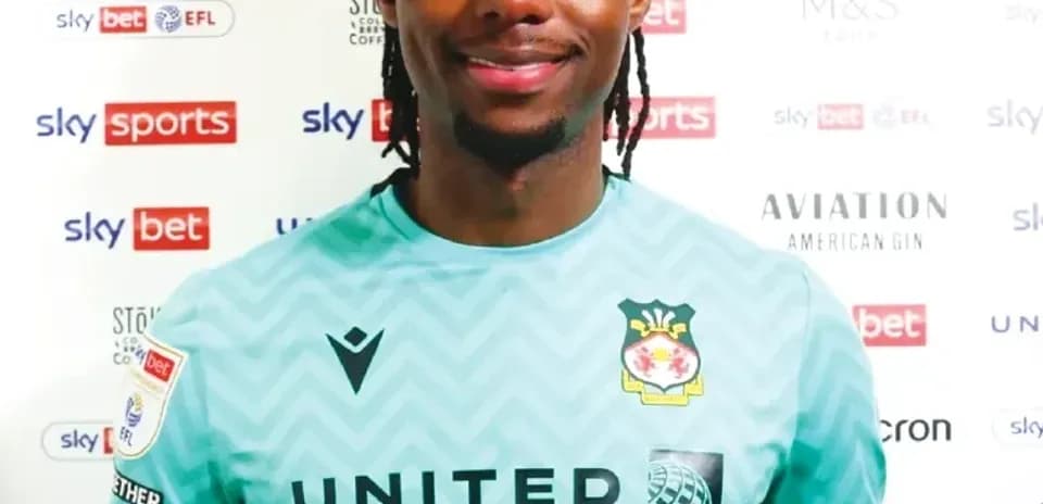Goalkeeper posing in team jersey at press event