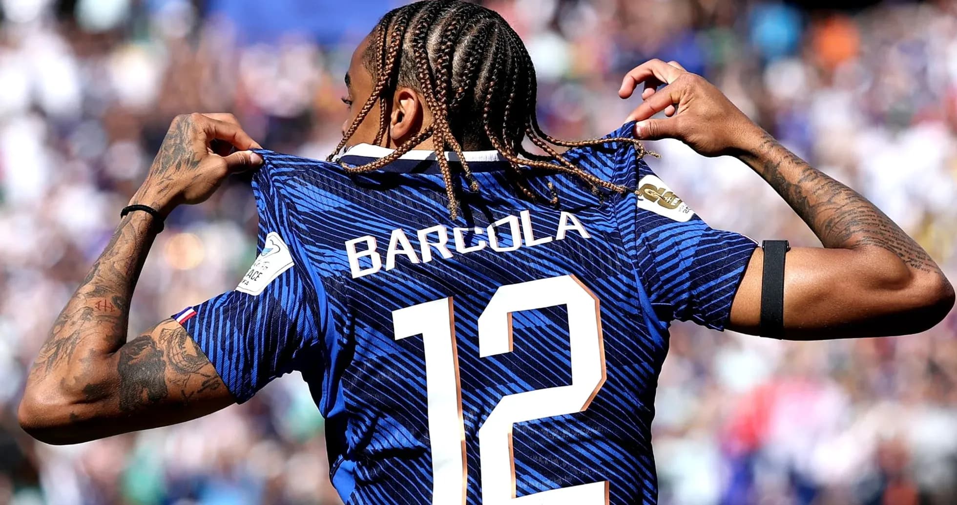 Player showcasing jersey with name Barcola and number 12