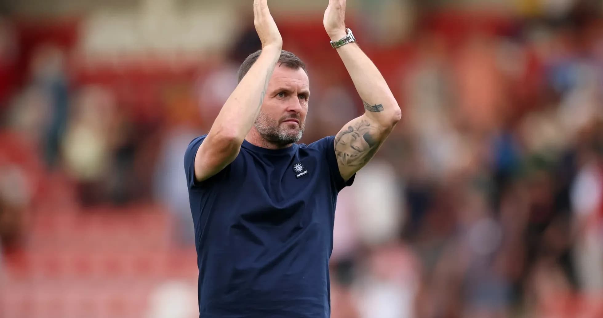 Coach applauding fans after the match