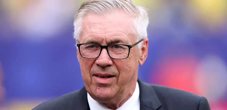 Coach in suit and glasses at event