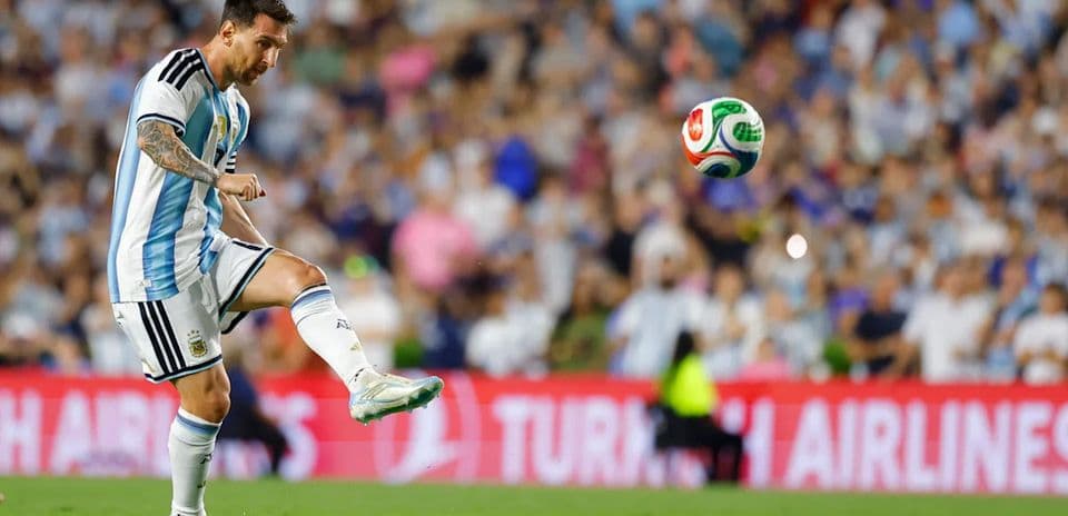 Lionel Messi preparing to kick the ball in match