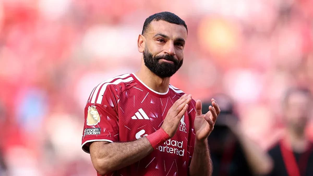 Player applauding fans in Liverpool jersey