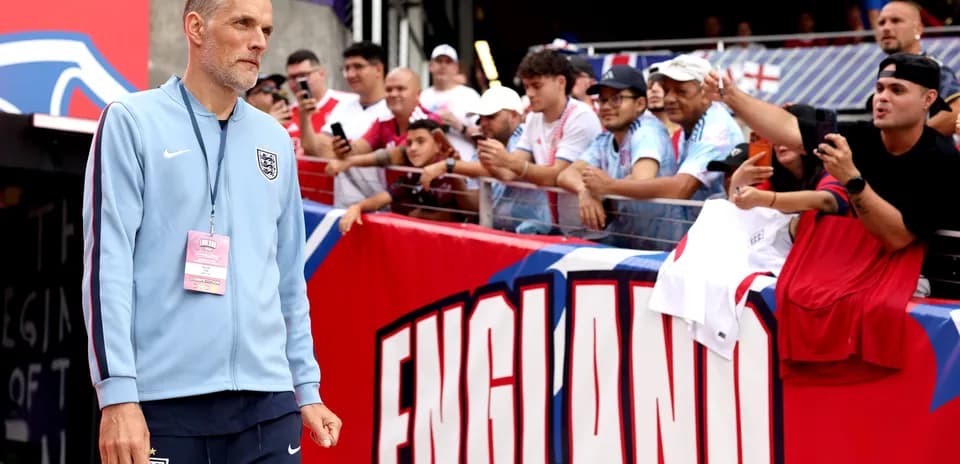 Coach walking past fans before the match
