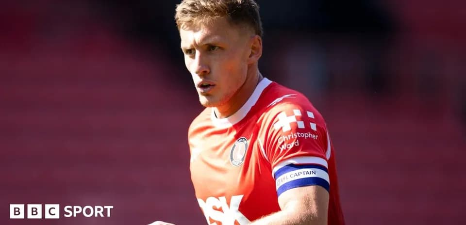 Player in red jersey with captain's armband