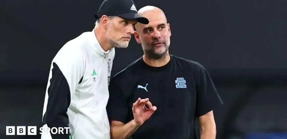 Two coaches discussing strategies on the field