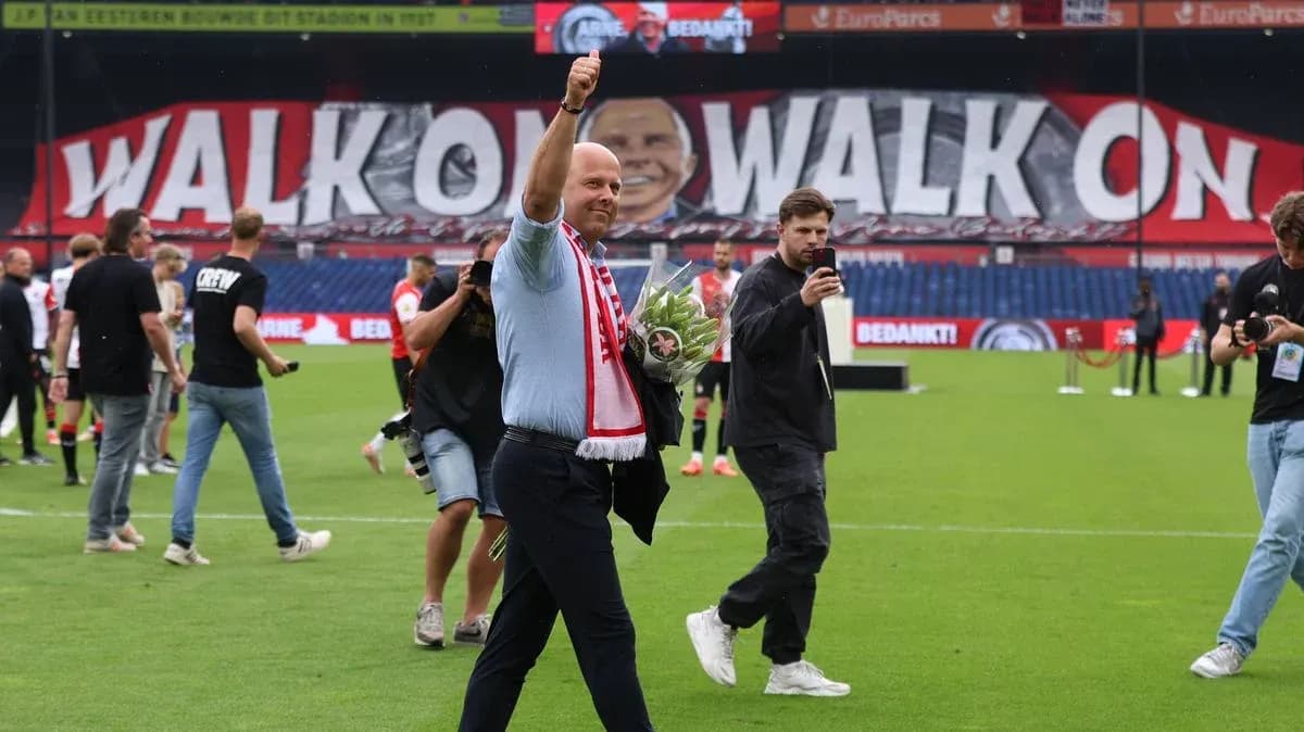 Coach waving with flowers on the pitch