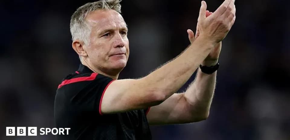 Manager applauding fans after the match