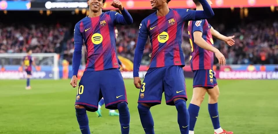 Two FC Barcelona players celebrating a goal