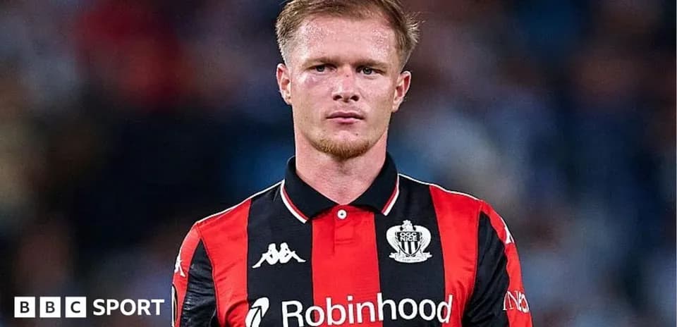 Player in red and black jersey on field