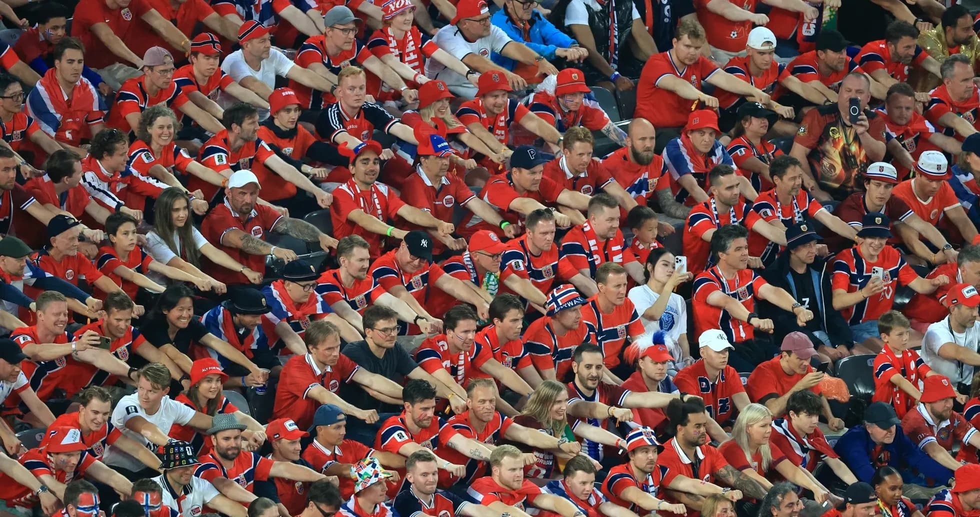 Crowd of fans in red shirts at stadium