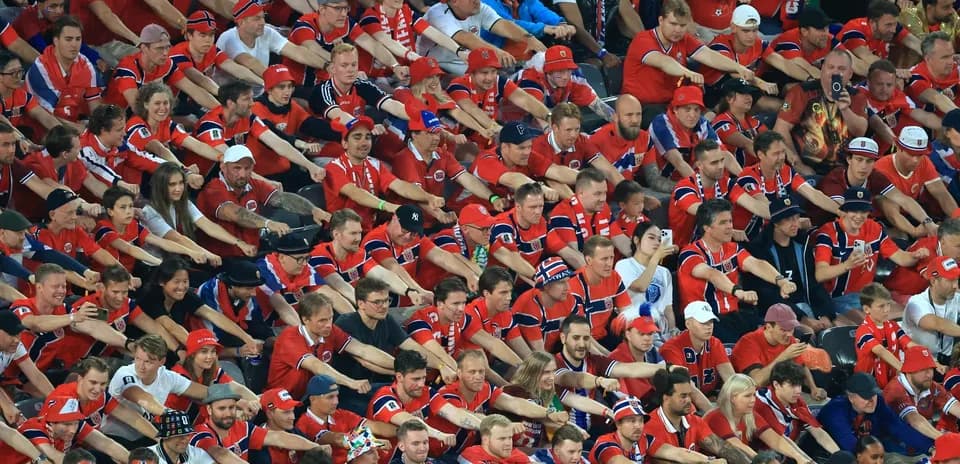Crowd of fans in red shirts at stadium