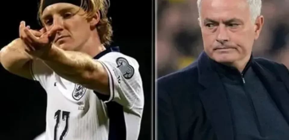 Player celebrating goal alongside coach during match